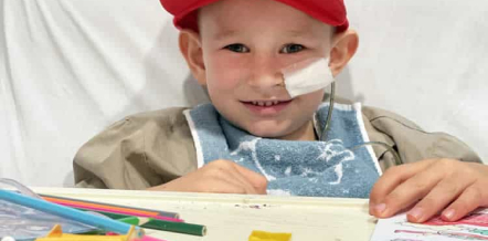 Image of child doing arts and crafts in bed