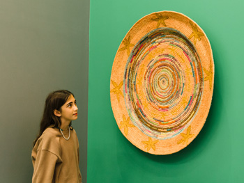 girl looking at artwork